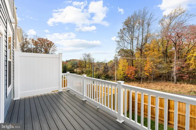 a view of a balcony with wooden floor and fence