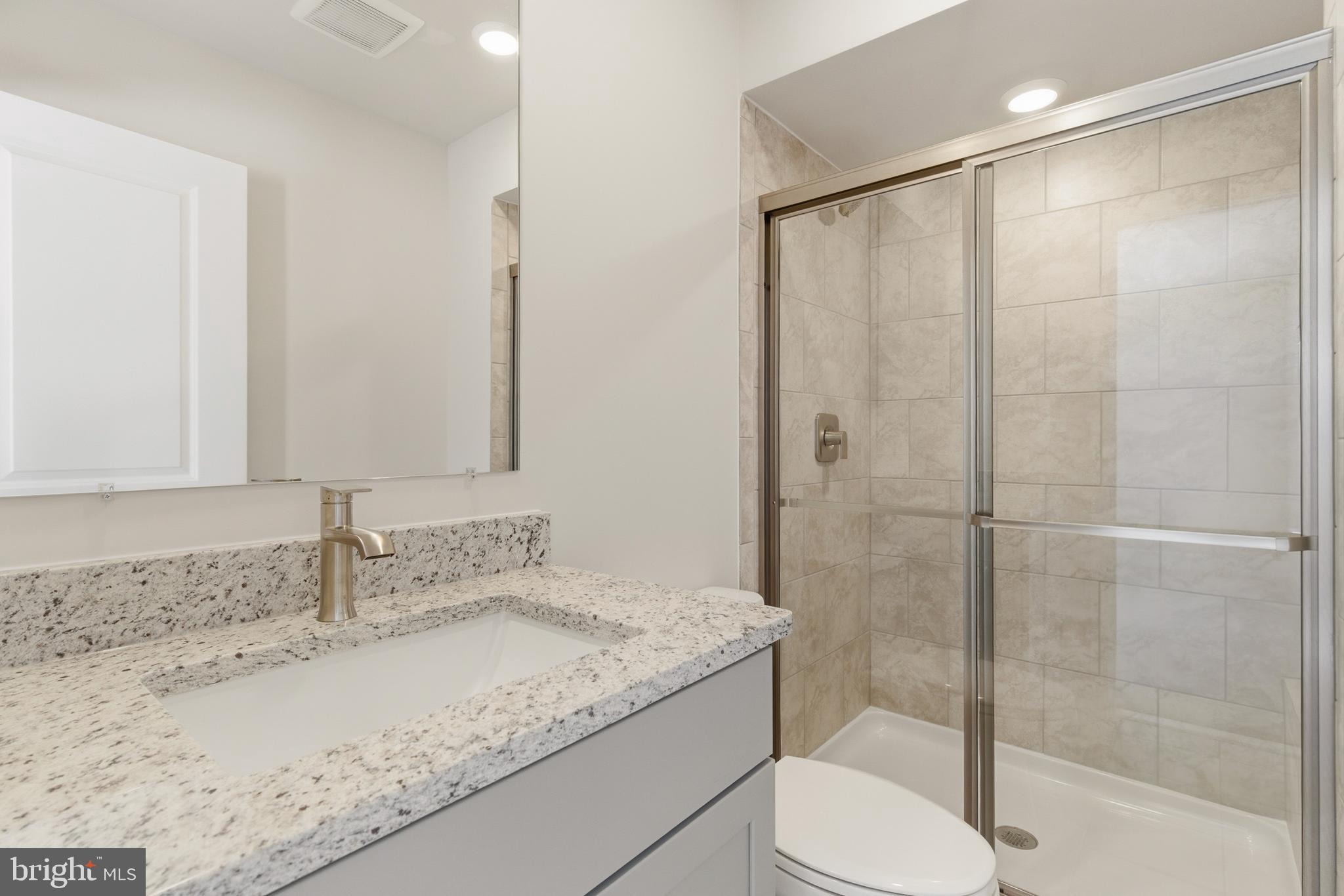 1722 Water Xing Road Baltimore, MD 21208 - Photo 34 of 41 a bathroom with a granite countertop sink toilet and shower