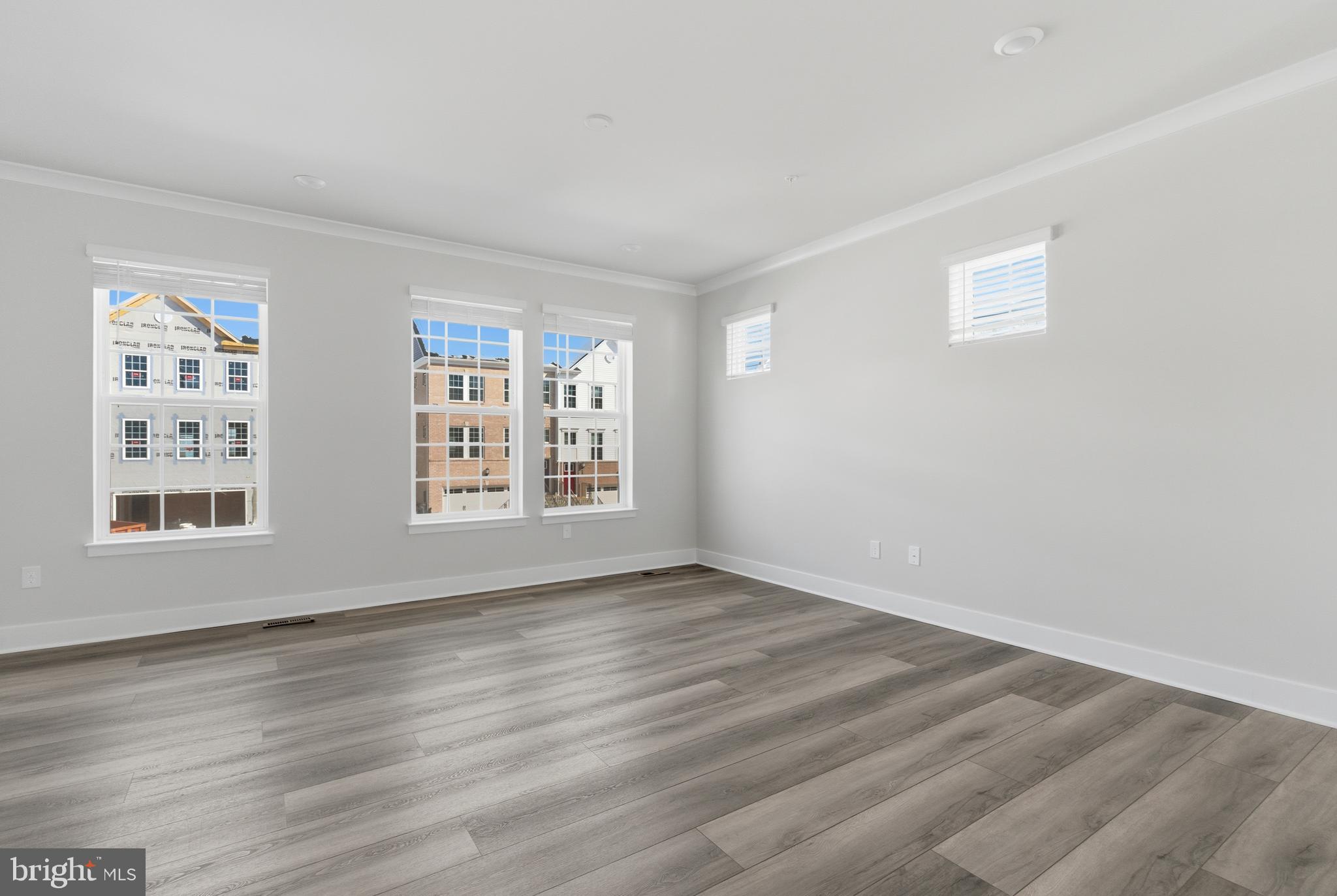 1722 Water Xing Road Baltimore, MD 21208 - Photo 4 of 41 a view of an empty room with wooden floor and a window