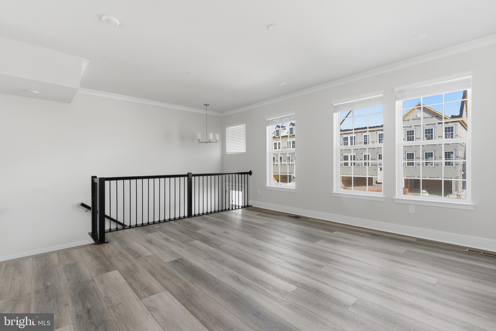 1722 Water Xing Road Baltimore, MD 21208 - Photo 5 of 41 a view of an empty room with wooden floor and a window