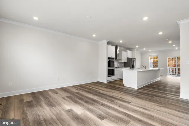 a view of kitchen with kitchen island refrigerator sink and stove