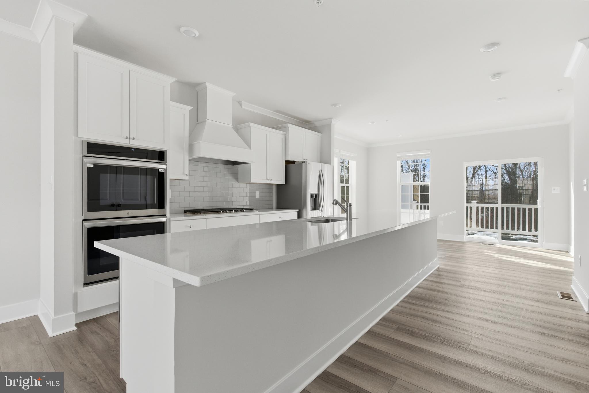 1722 Water Xing Road Baltimore, MD 21208 - Photo 7 of 41 a large kitchen with stainless steel appliances a large counter top and a stove