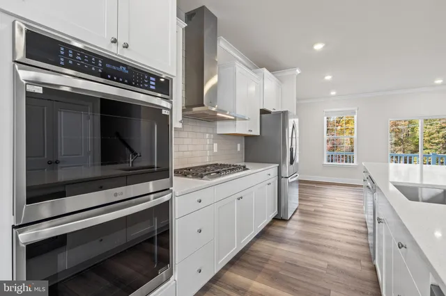 a kitchen with stainless steel appliances a stove microwave and cabinets