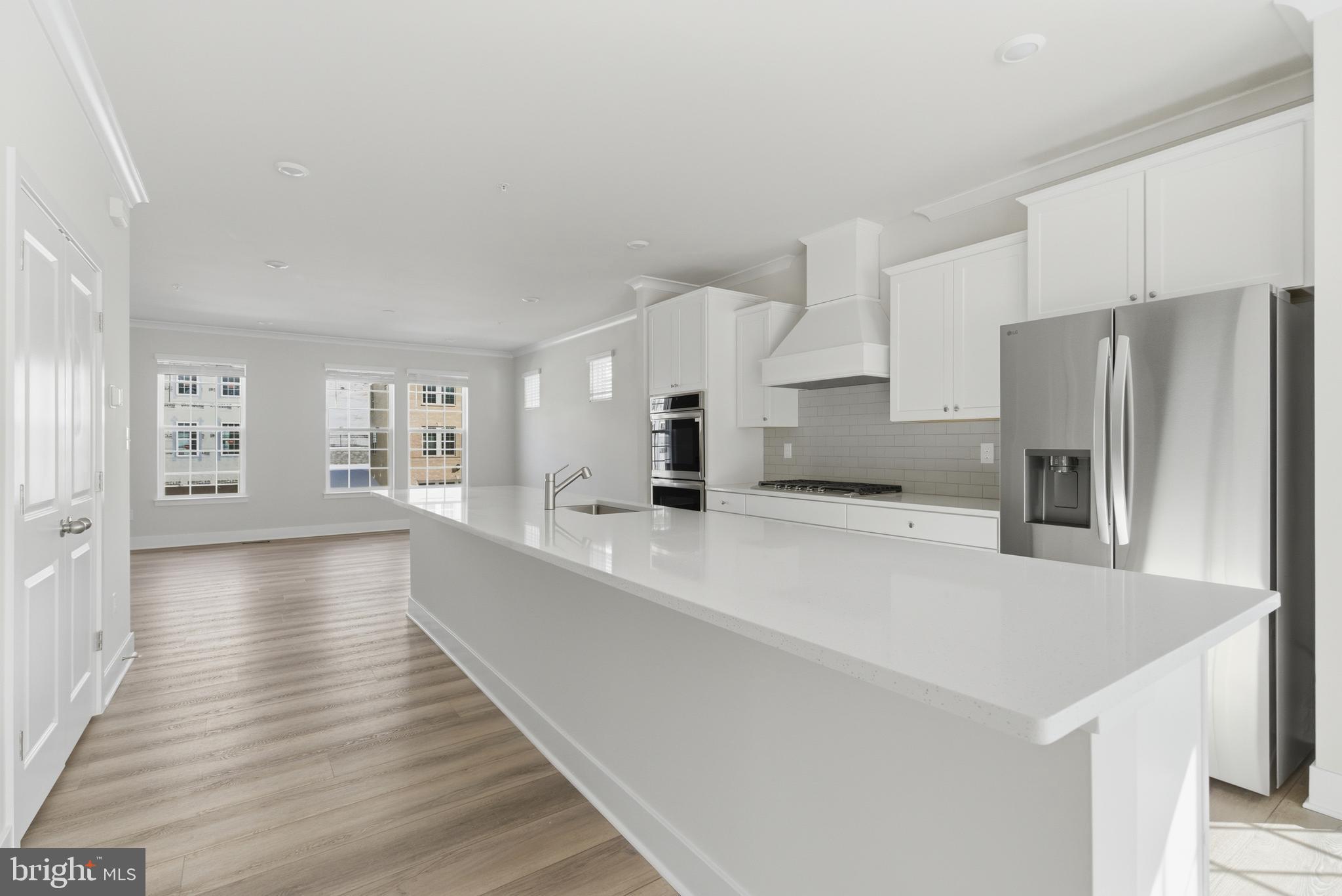 1722 Water Xing Road Baltimore, MD 21208 - Photo 8 of 41 a large white kitchen with a center island and stainless steel appliances