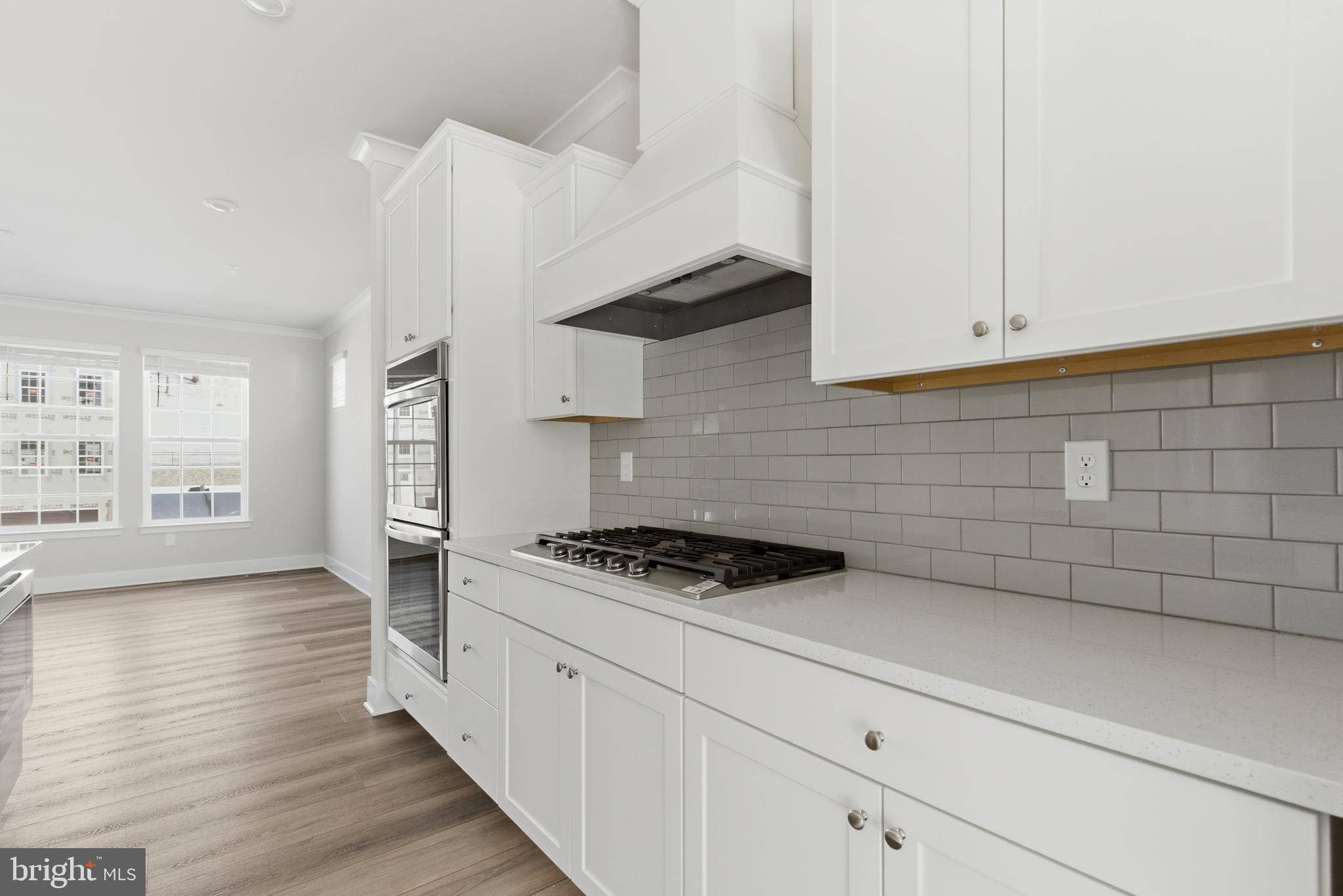 1722 Water Xing Road Baltimore, MD 21208 - Photo 9 of 41 a kitchen with granite countertop a stove a sink and white cabinets