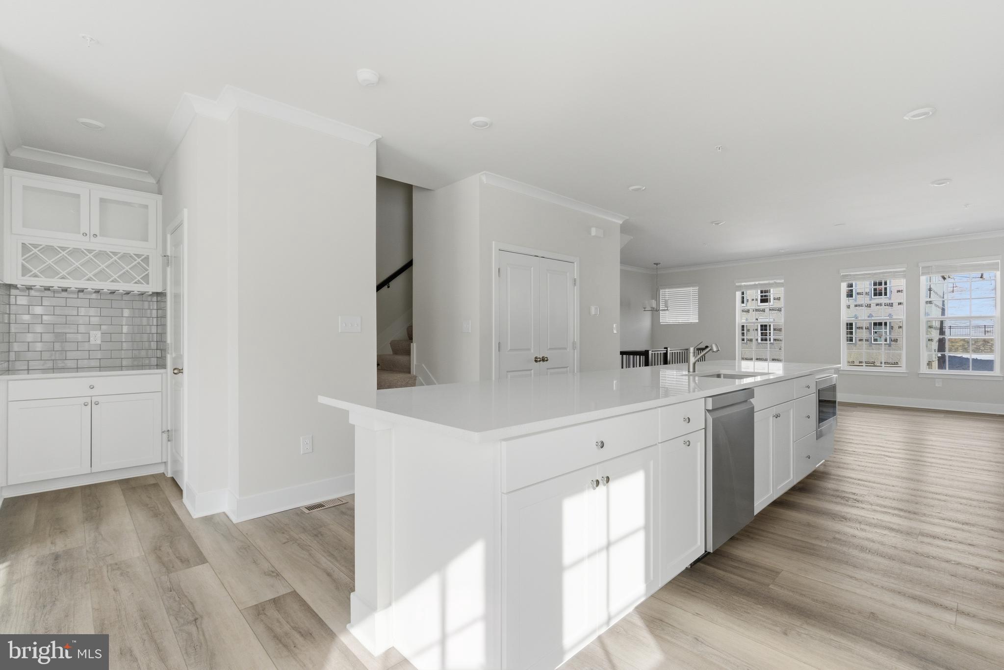 1722 Water Xing Road Baltimore, MD 21208 - Photo 10 of 41 a large white kitchen with wooden floors and white walls