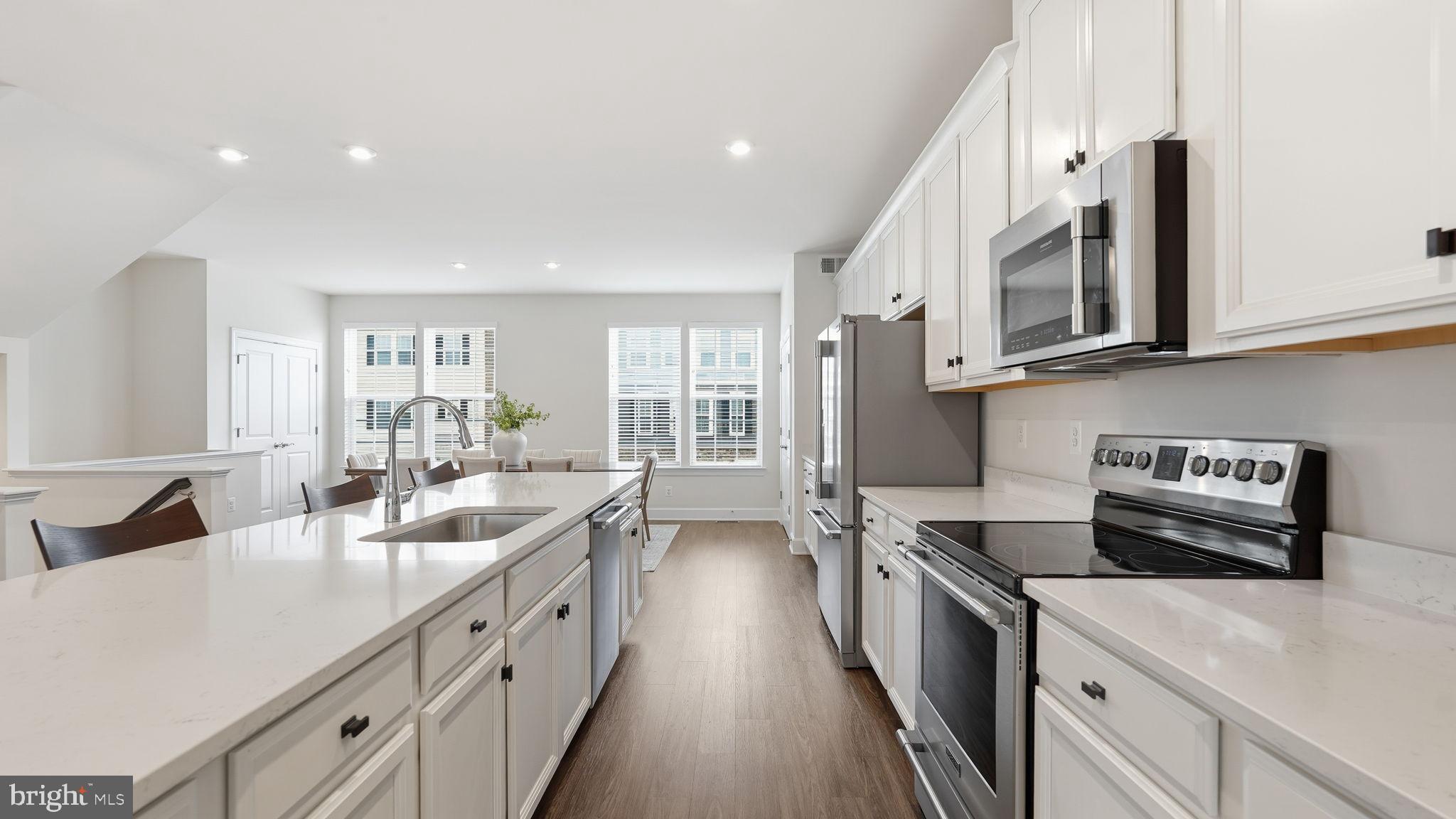 10644 Hinton Way Manassas, VA 20112 - Photo 13 of 44 a large white kitchen with stainless steel appliances granite countertop a lot of counter space and a sink