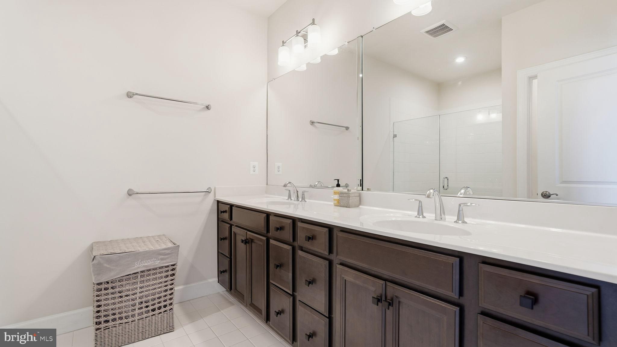 10644 Hinton Way Manassas, VA 20112 - Photo 23 of 44 a bathroom with a double vanity sink and a mirror