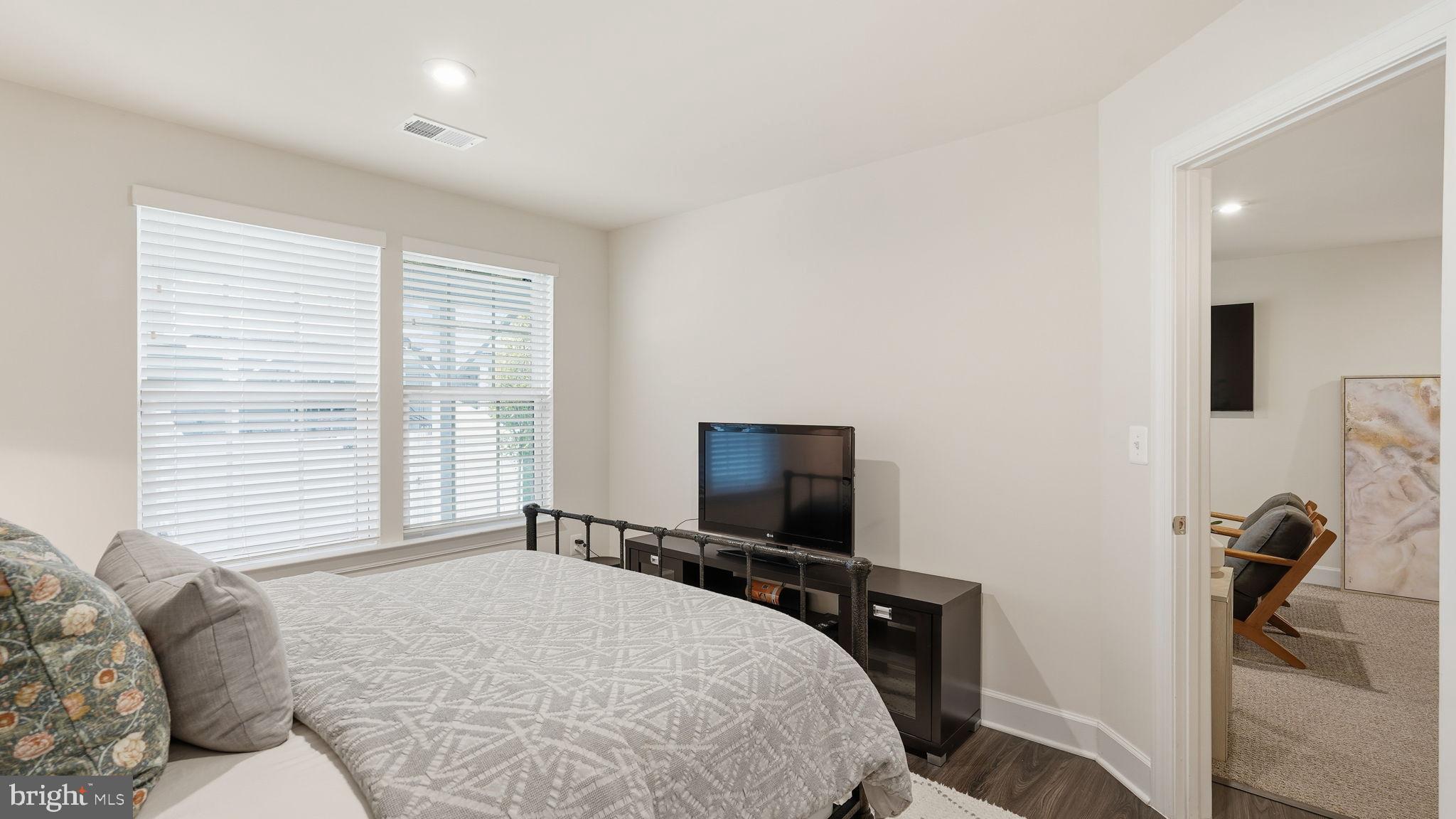 10644 Hinton Way Manassas, VA 20112 - Photo 32 of 44 a bedroom with a bed and a flat screen tv