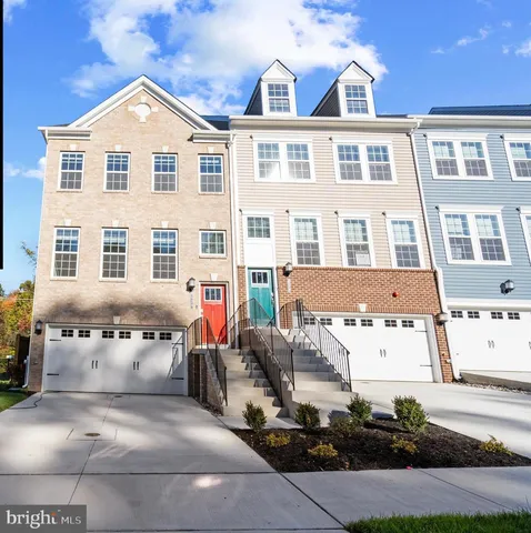 a front view of a residential apartment building with a yard