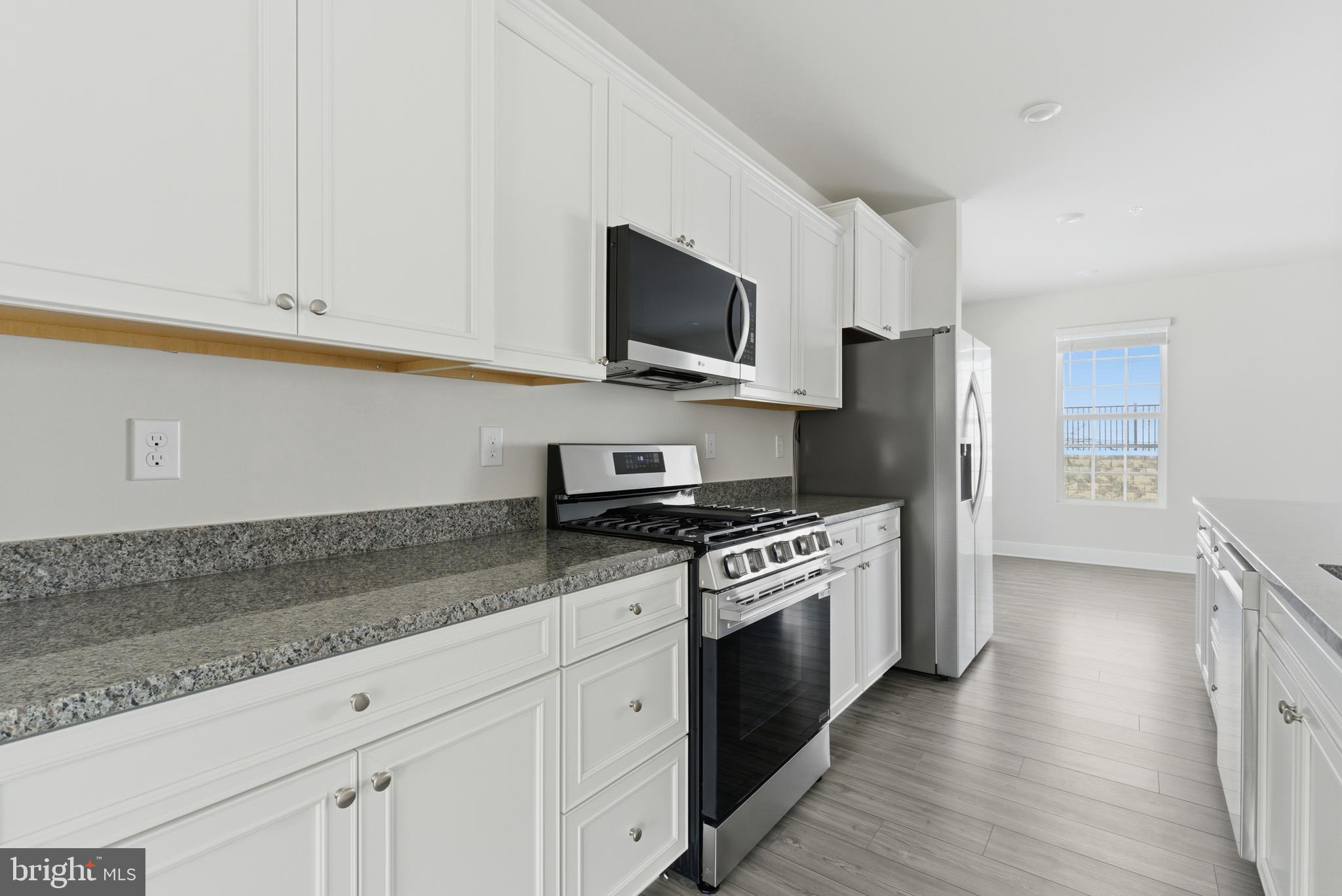 1723 Water Xing Road Pikesville, MD 21208 - Photo 11 of 37 a kitchen with stainless steel appliances granite countertop a stove a sink and a refrigerator