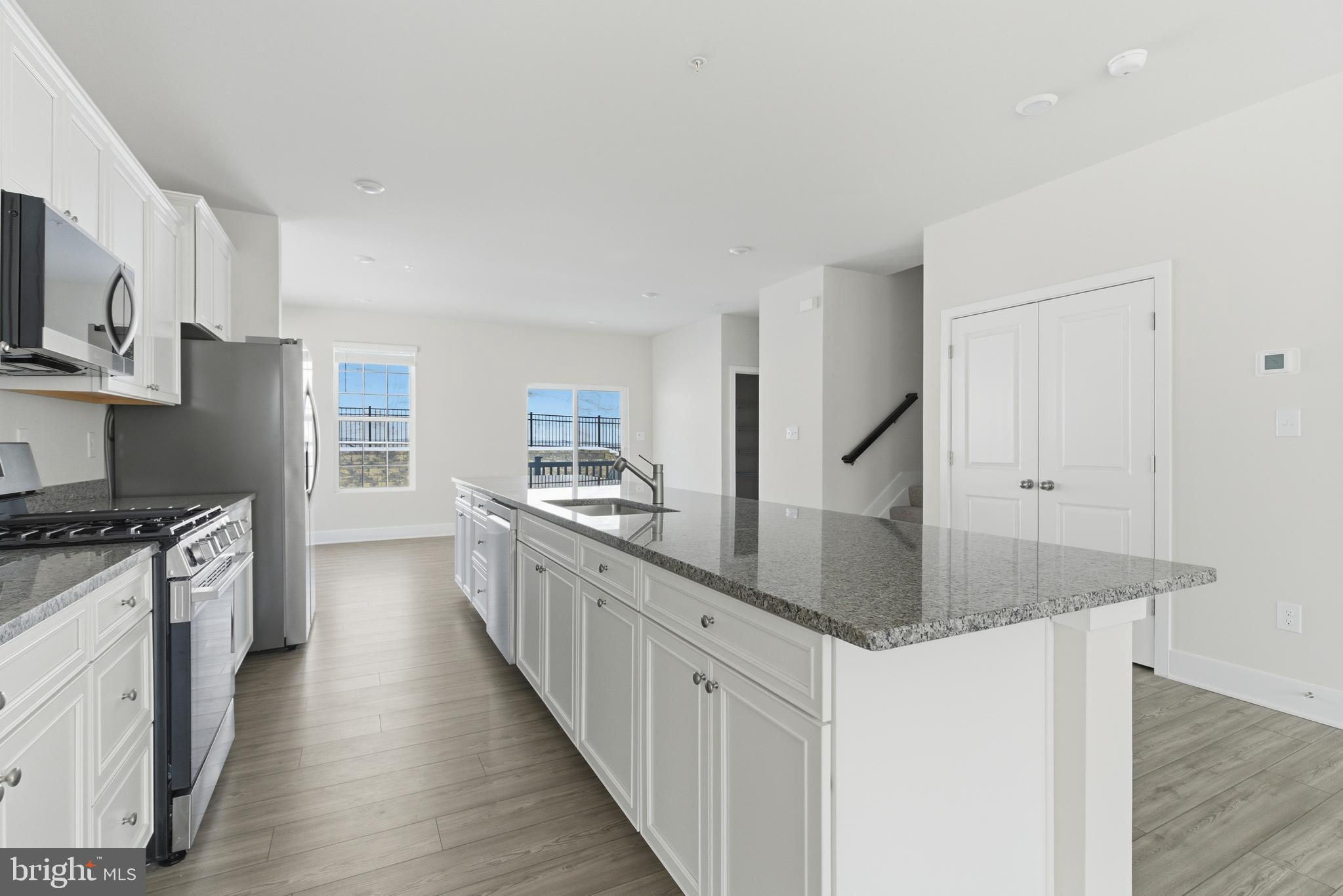 1723 Water Xing Road Pikesville, MD 21208 - Photo 12 of 37 a large kitchen with stainless steel appliances granite countertop a lot of counter space and wooden floor