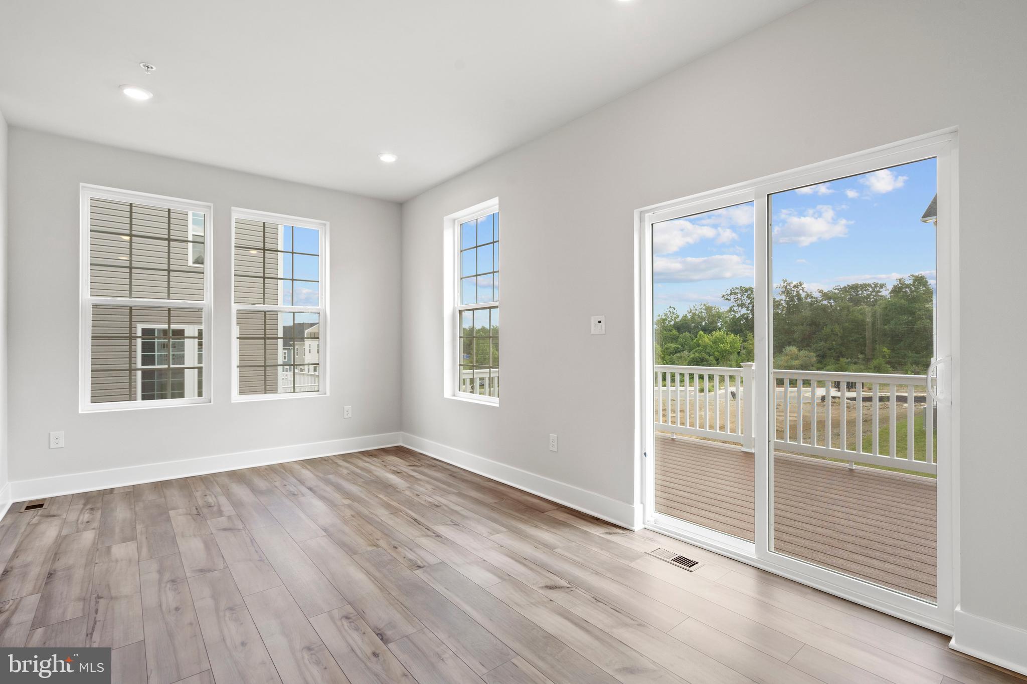1723 Water Xing Road Pikesville, MD 21208 - Photo 15 of 32 a view of empty room with wooden floor and fan