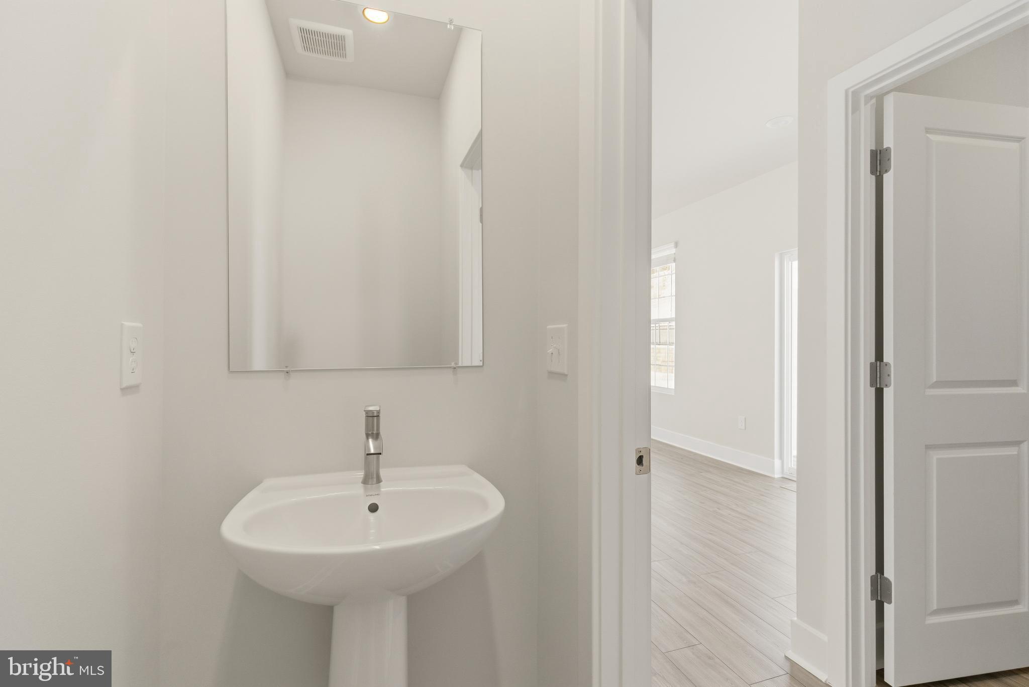 1723 Water Xing Road Pikesville, MD 21208 - Photo 18 of 37 a bathroom with a sink and a mirror