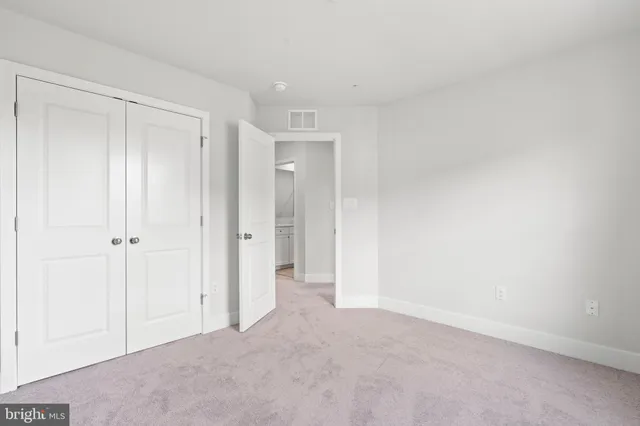 a view of an empty room and closet area