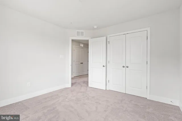 a view of an empty room and closet area