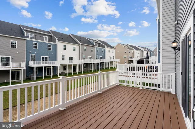 a view of a large building with a wooden deck