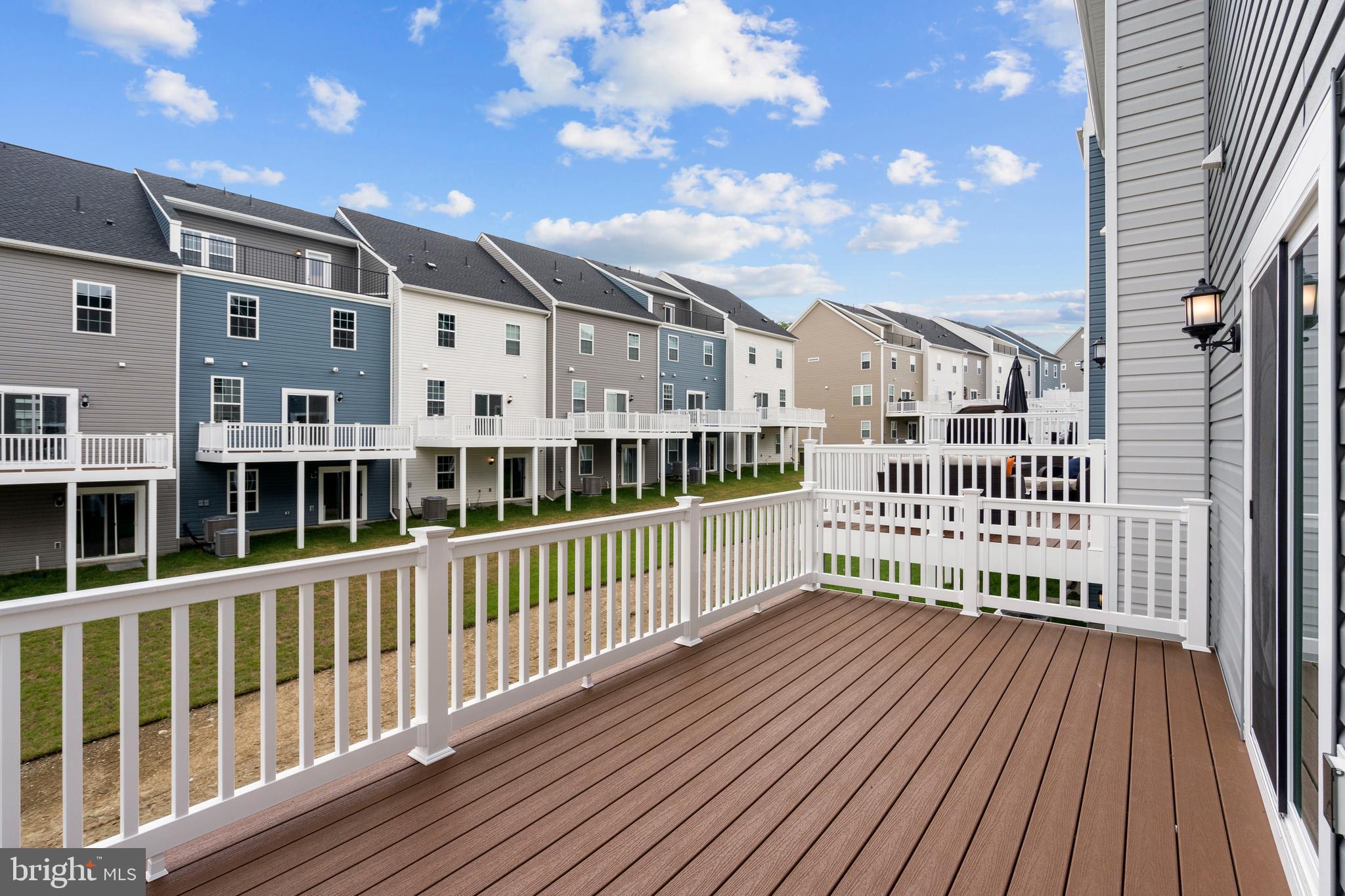 1723 Water Xing Road Pikesville, MD 21208 - Photo 32 of 32 a view of a large building with a wooden deck