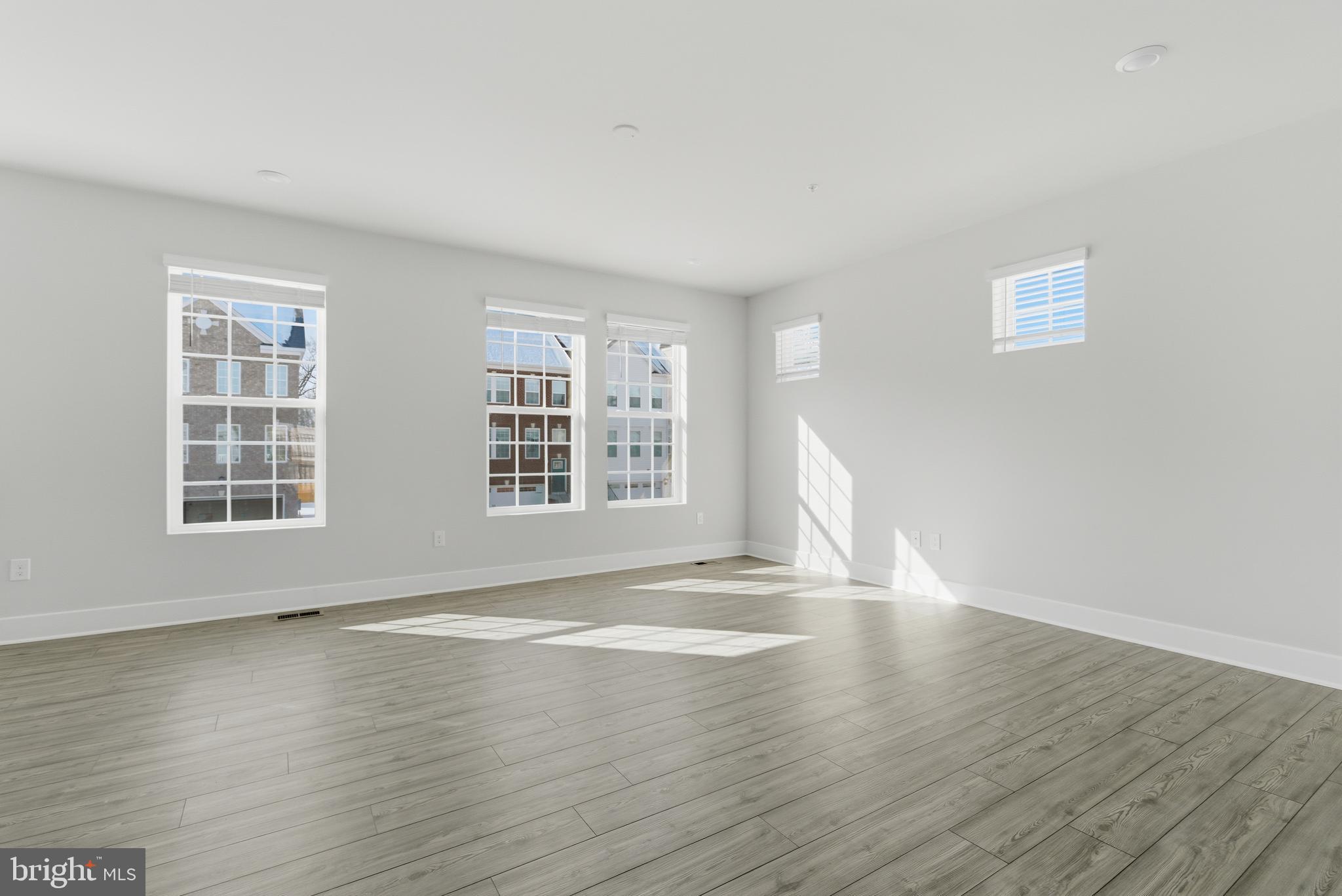 1723 Water Xing Road Pikesville, MD 21208 - Photo 4 of 37 an empty room with wooden floor and windows