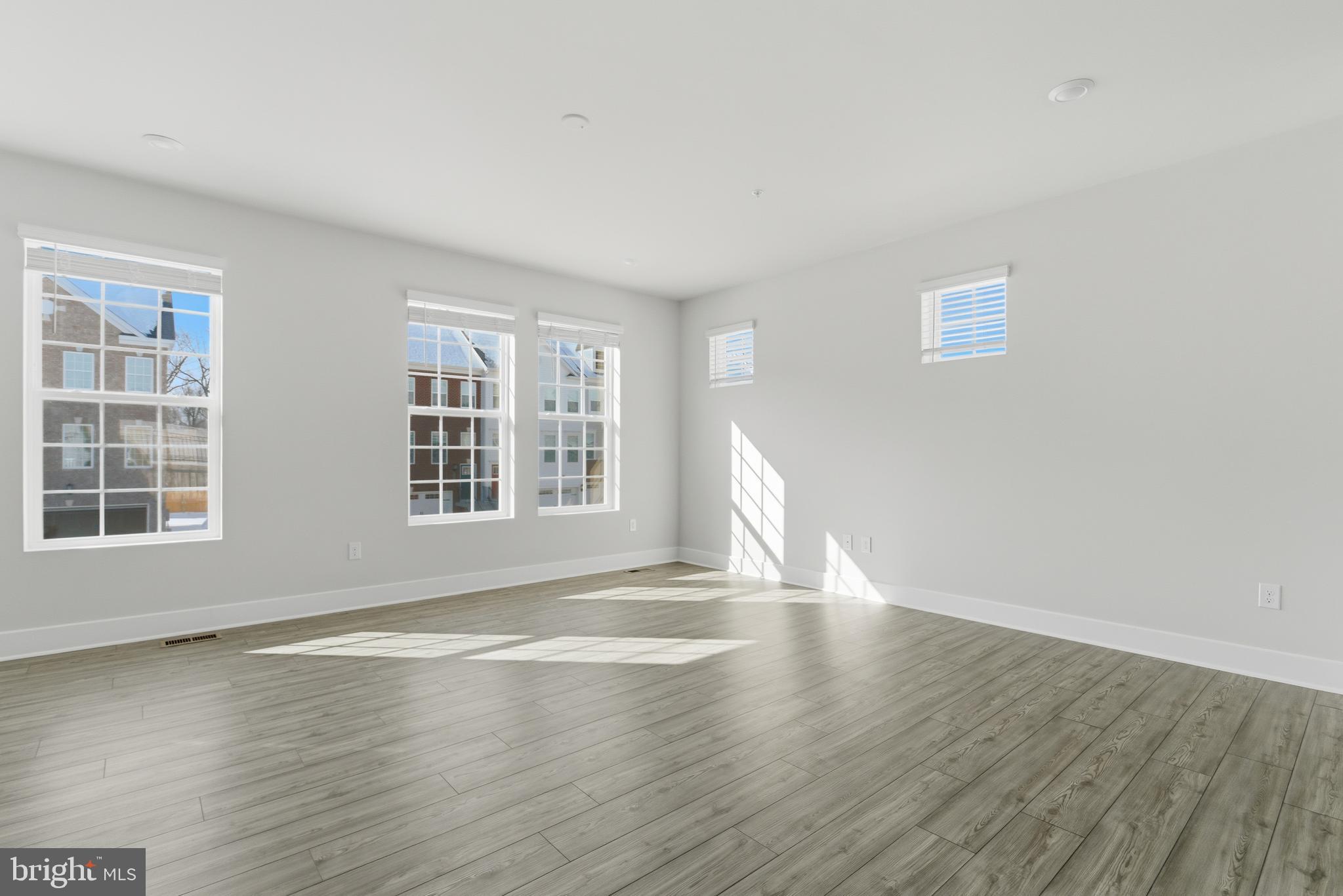 1723 Water Xing Road Pikesville, MD 21208 - Photo 8 of 37 a view of empty room with wooden floor and fan