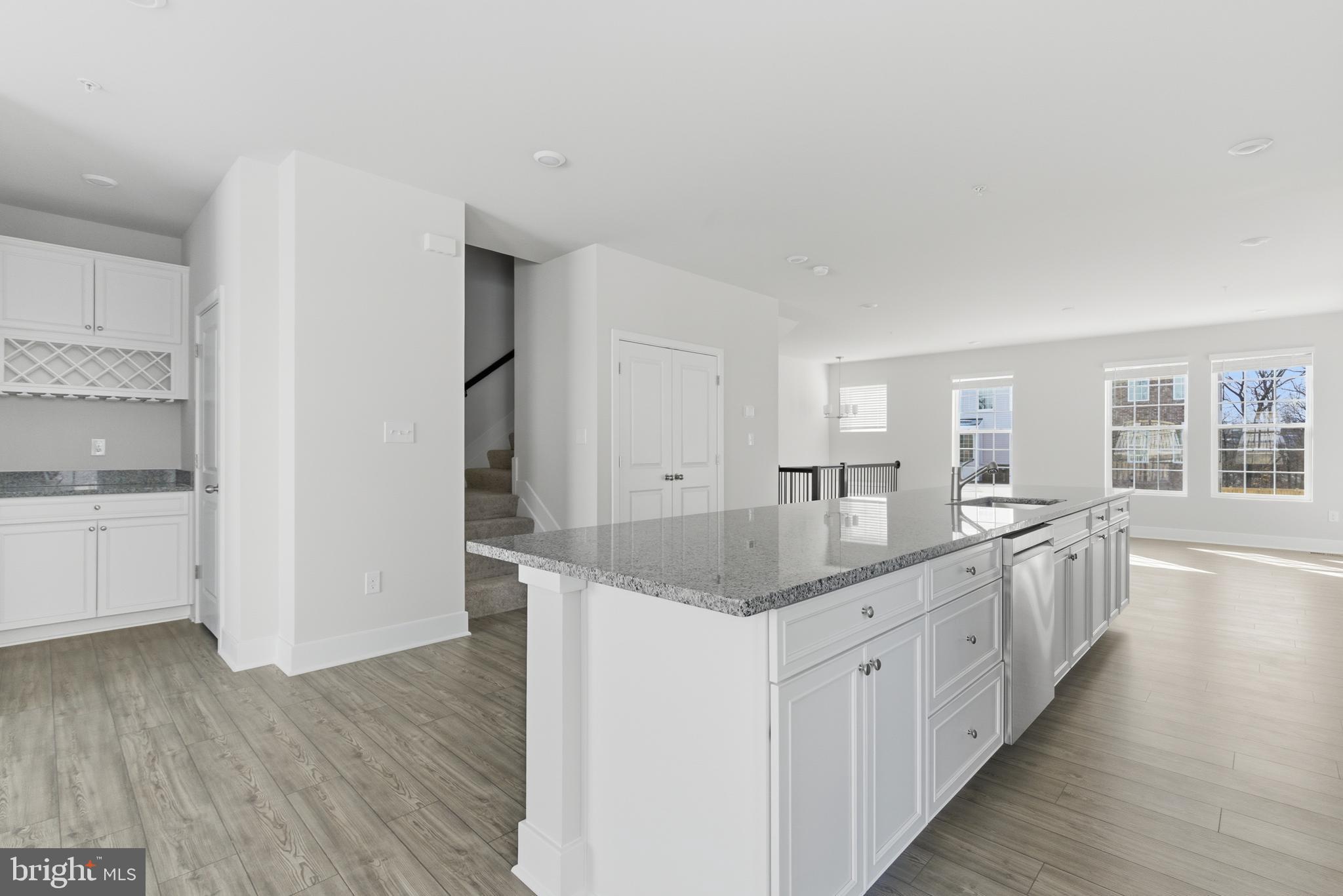 1723 Water Xing Road Pikesville, MD 21208 - Photo 10 of 37 a kitchen with granite countertop white cabinets and white appliances