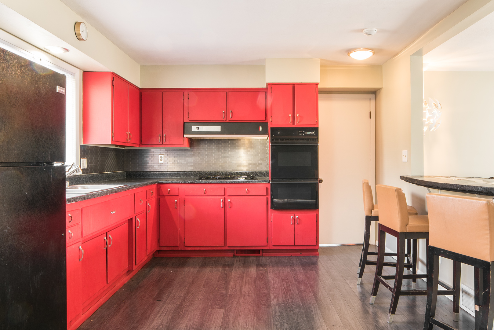930 Normal Road DeKalb, IL 60115 - Photo 11 of 35 a kitchen with stainless steel appliances granite countertop a stove top oven a sink and a refrigerator