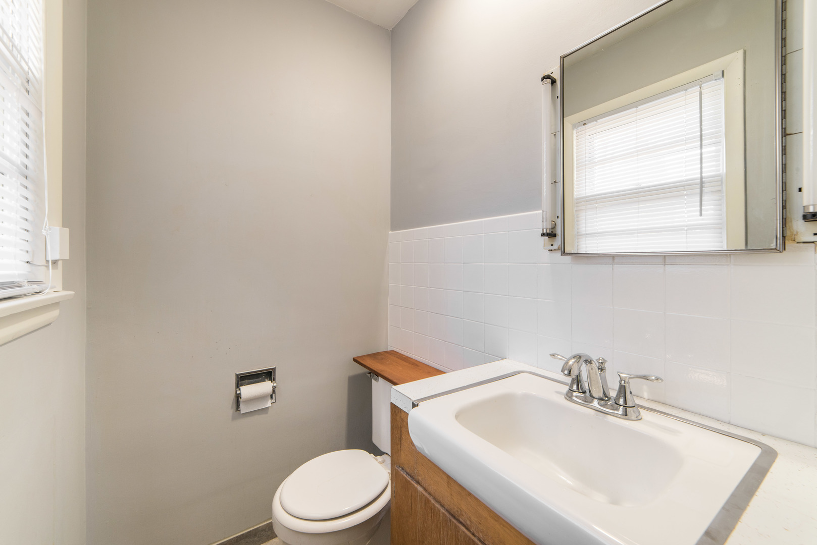 930 Normal Road DeKalb, IL 60115 - Photo 17 of 35 a bathroom with a sink a toilet and a mirror
