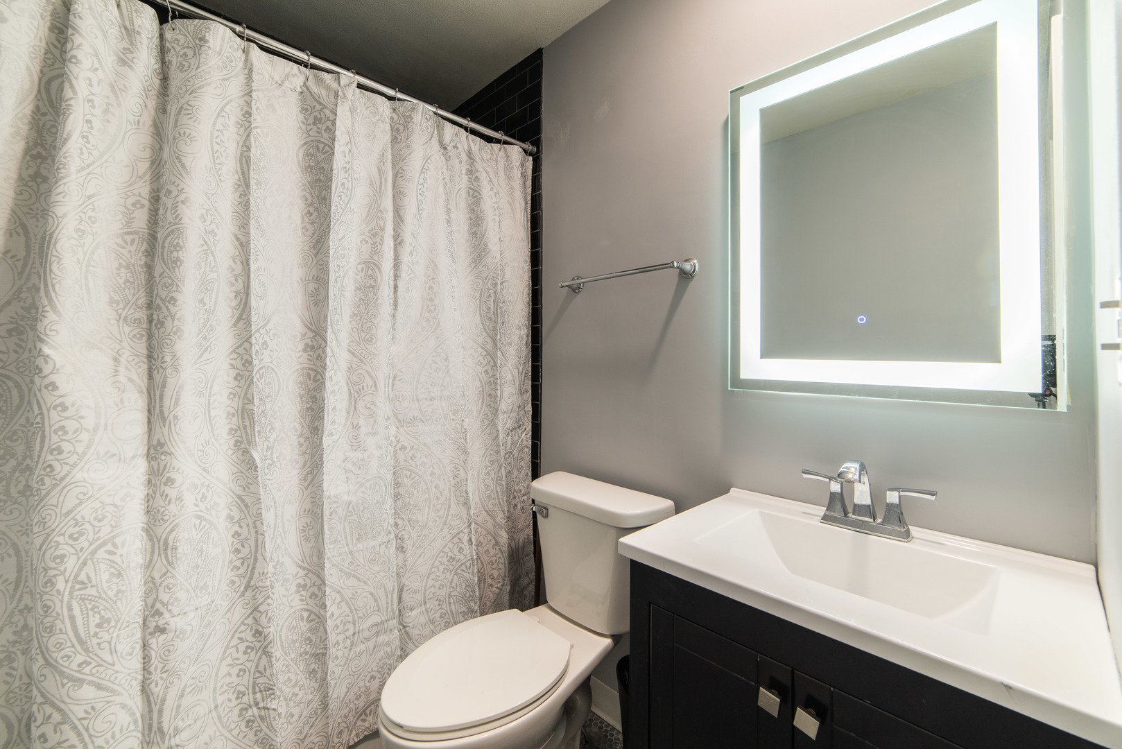 930 Normal Road DeKalb, IL 60115 - Photo 21 of 35 a bathroom with a sink a toilet and shower curtain