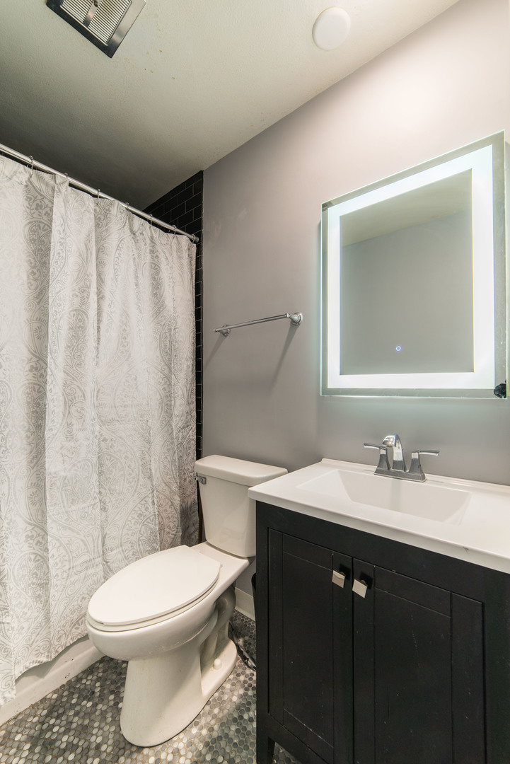 930 Normal Road DeKalb, IL 60115 - Photo 22 of 35 a bathroom with a sink a toilet and shower