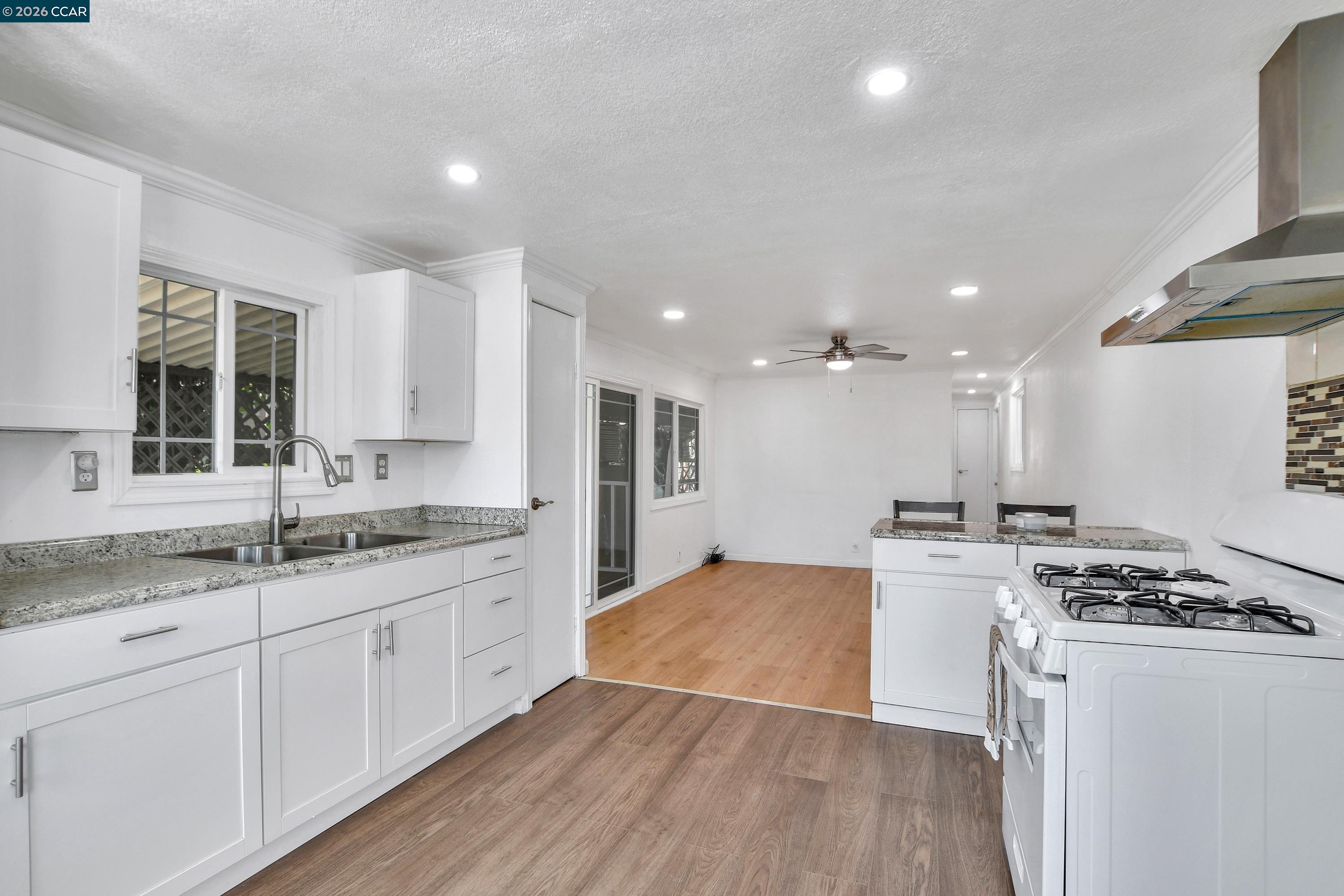 237 Orangevale Pittsburg, CA 94565 - Photo 6 of 21 a kitchen with stainless steel appliances granite countertop a sink stove and refrigerator