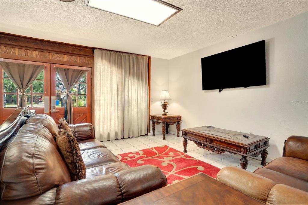 7905 Pierce Harwell Road Plant City, FL 33565 - Photo 12 of 68 a bedroom with a bed and a flat screen tv