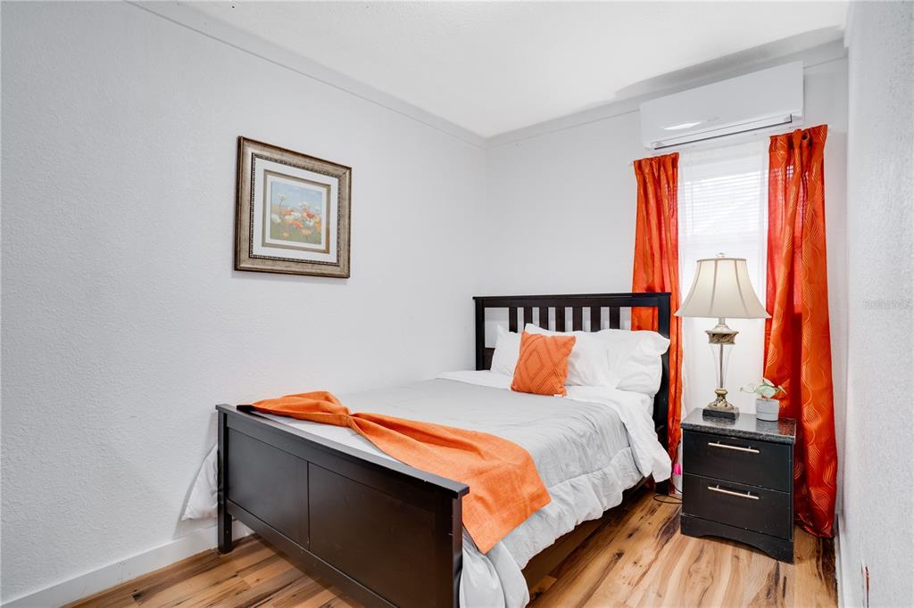 7905 Pierce Harwell Road Plant City, FL 33565 - Photo 17 of 68 a bed sitting in a bedroom next to a window