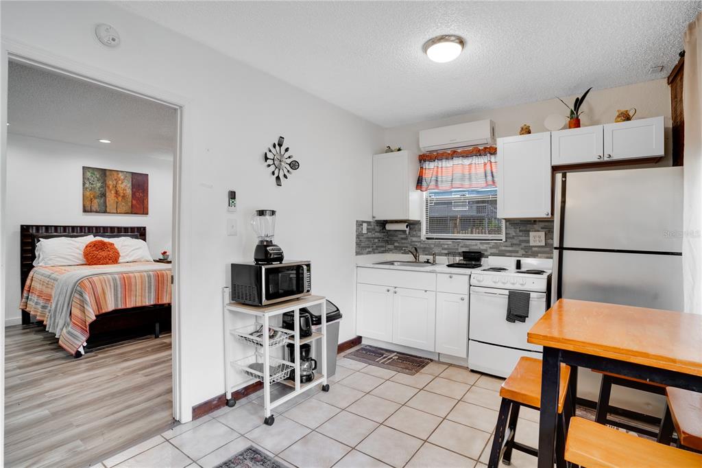 7905 Pierce Harwell Road Plant City, FL 33565 - Photo 22 of 68 a kitchen with a refrigerator and a stove top oven