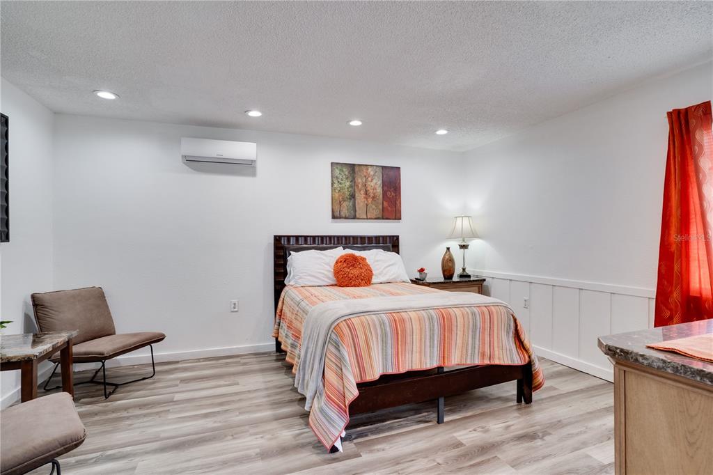 7905 Pierce Harwell Road Plant City, FL 33565 - Photo 24 of 68 a bedroom with a bed and a chair