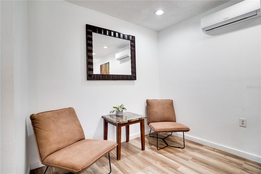 7905 Pierce Harwell Road Plant City, FL 33565 - Photo 25 of 68 a blue chair sitting in a room next to a chair