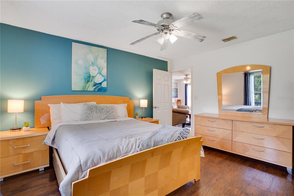 7905 Pierce Harwell Road Plant City, FL 33565 - Photo 27 of 68 a bedroom with a large bed a chandelier and dresser