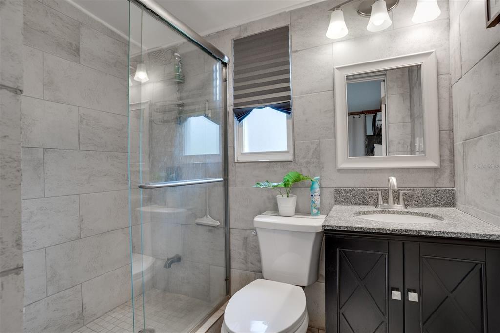 7905 Pierce Harwell Road Plant City, FL 33565 - Photo 39 of 68 a bathroom with a sink toilet and shower