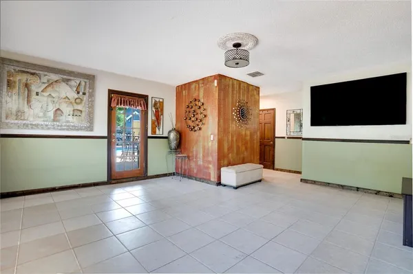 a view of an empty room with a flat screen tv