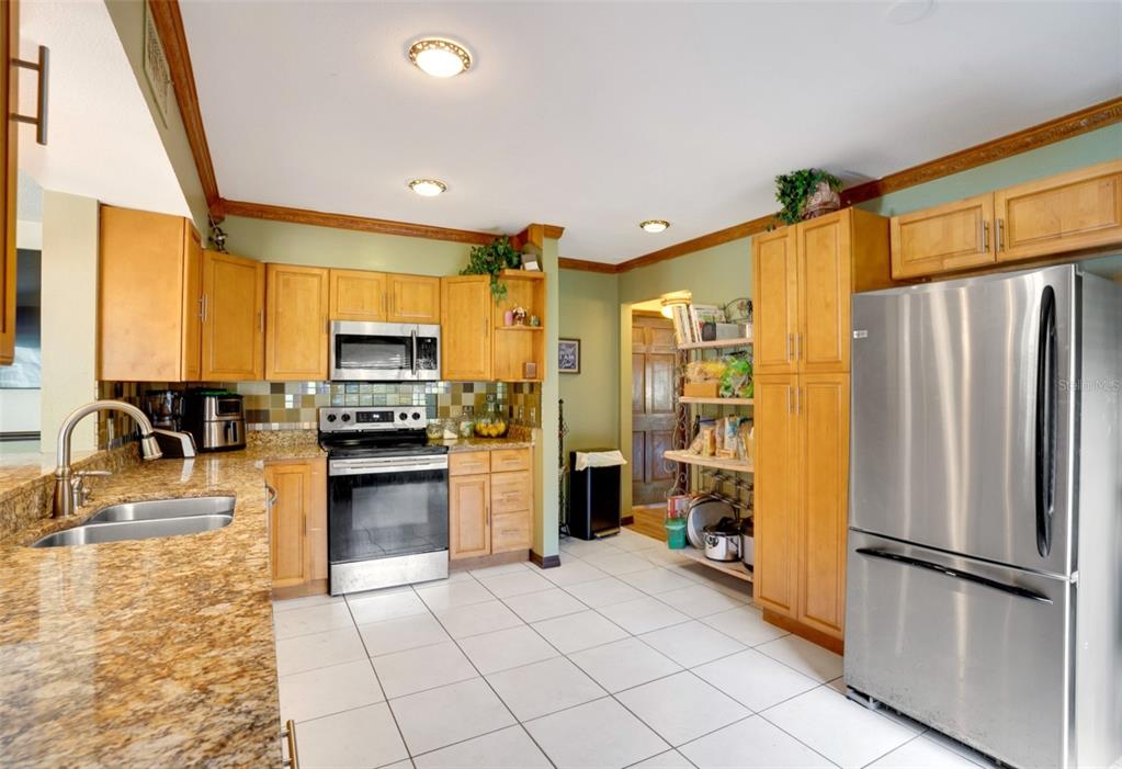 7905 Pierce Harwell Road Plant City, FL 33565 - Photo 67 of 68 a kitchen with a refrigerator a stove top oven and a sink