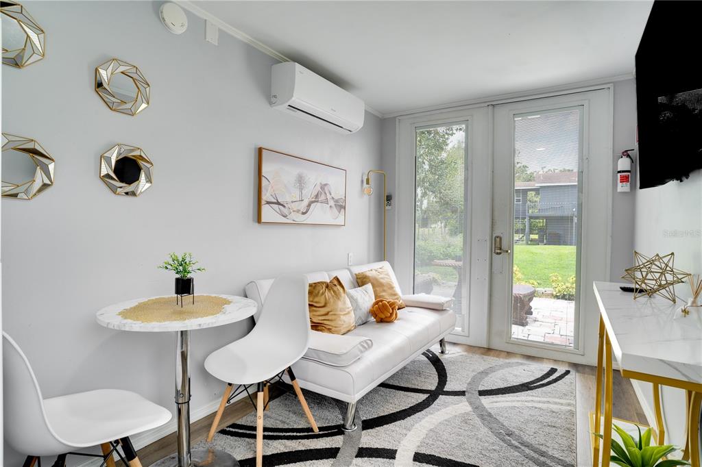 7905 Pierce Harwell Road Plant City, FL 33565 - Photo 9 of 68 a living room with furniture and a floor to ceiling window