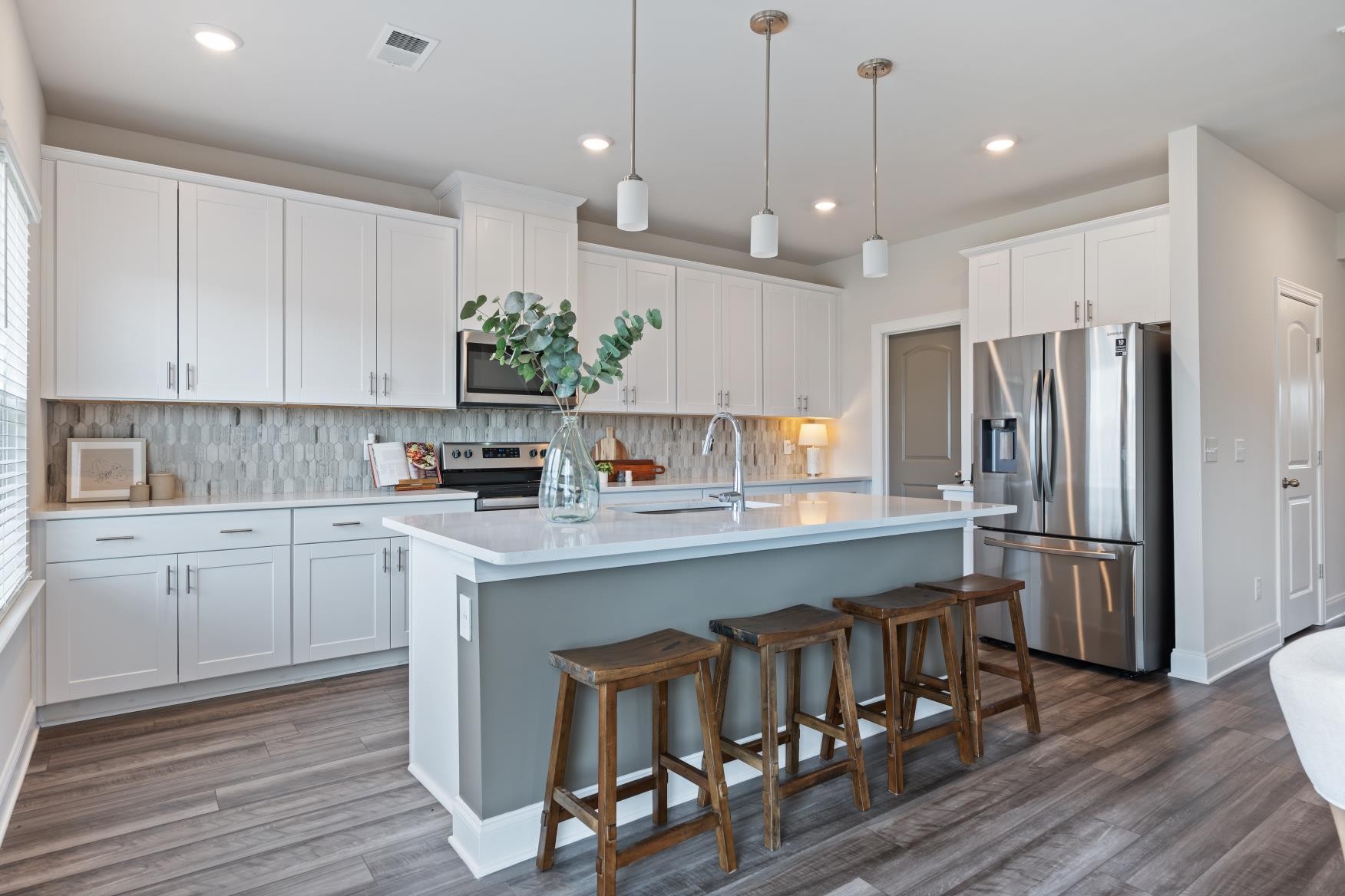 3706 Mathewson Way Murfreesboro, TN 37128 - Photo 14 of 59 a kitchen with kitchen island a refrigerator a stove a sink and white cabinets with wooden floor