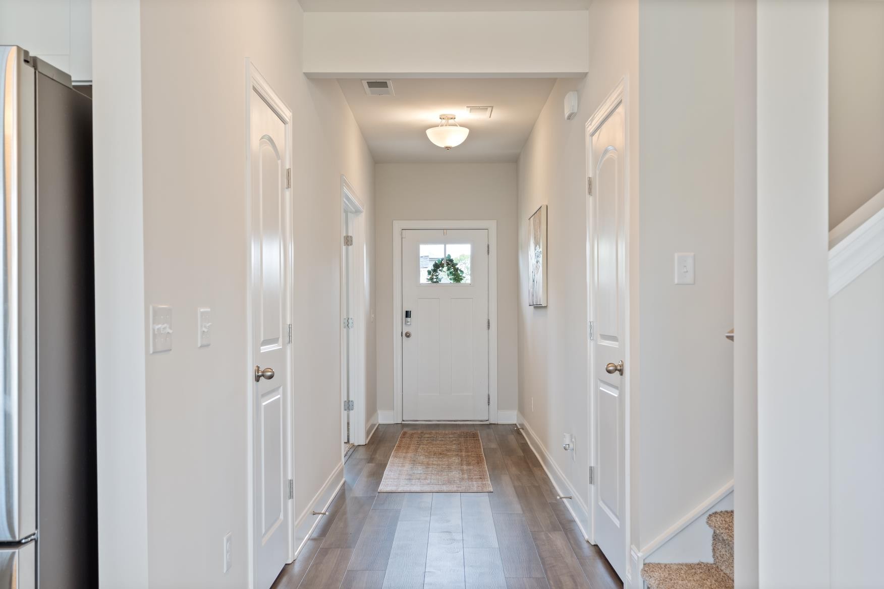 3706 Mathewson Way Murfreesboro, TN 37128 - Photo 9 of 59 a view of a hallway with wooden floor and a mirror