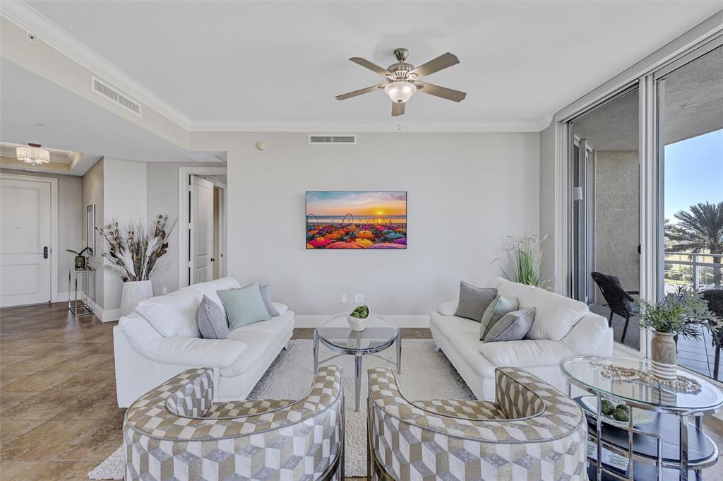 140 Riviera Dunes Way, Unit 206 Palmetto, FL 34221 - Photo 7 of 46 a living room with furniture a rug and a chandelier