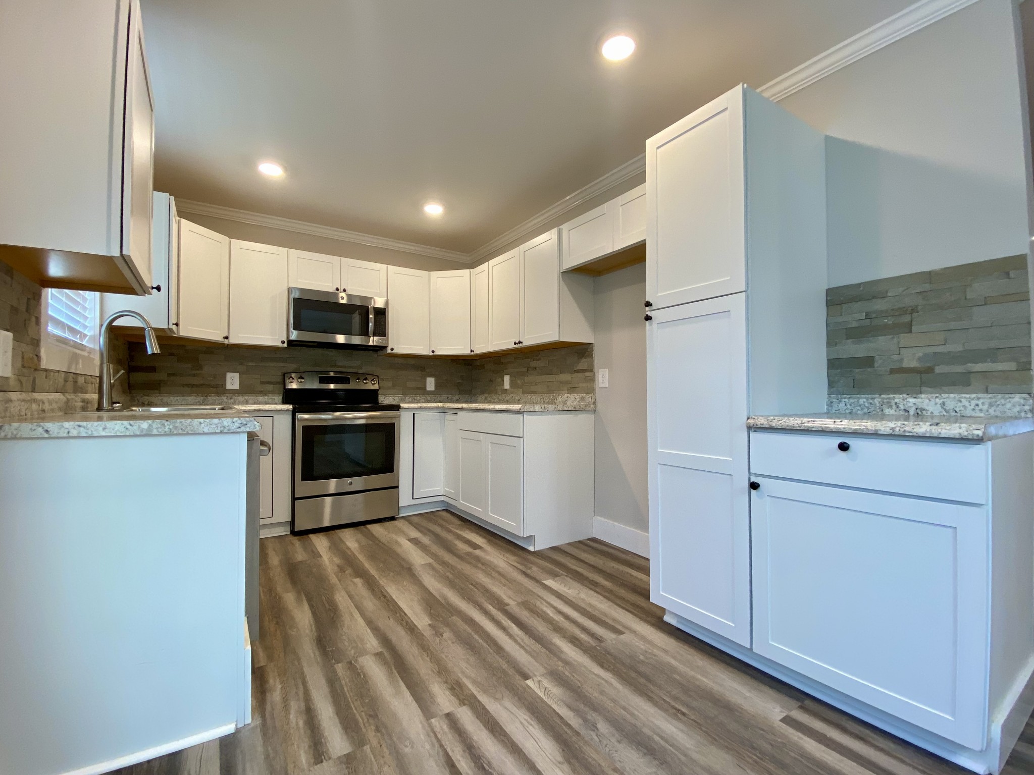 90 Allred Road Decherd, TN 37324 - Photo 20 of 22 a kitchen with stainless steel appliances granite countertop a stove a sink and a microwave