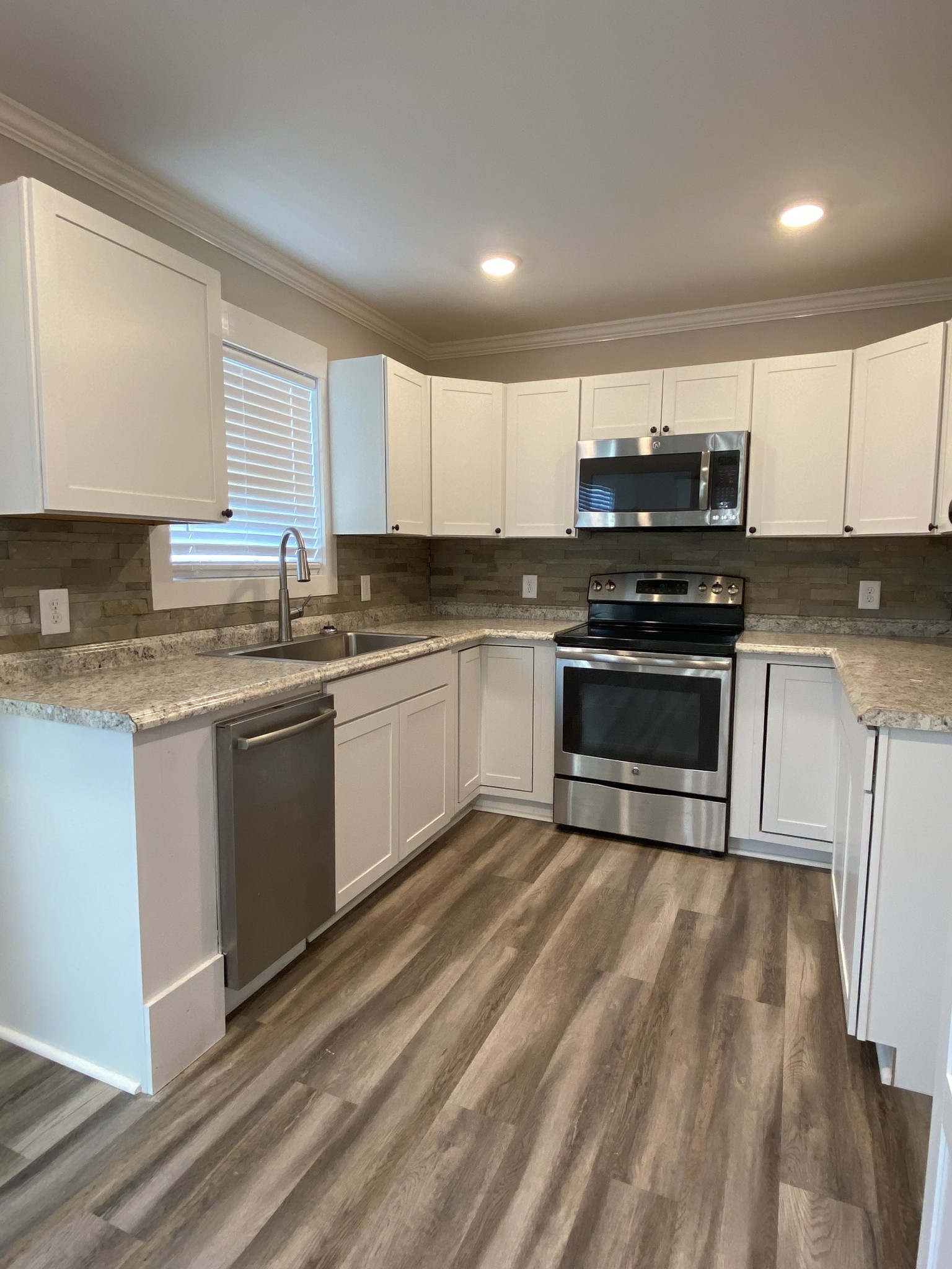 90 Allred Road Decherd, TN 37324 - Photo 21 of 22 a kitchen with stainless steel appliances granite countertop a stove a sink and a microwave