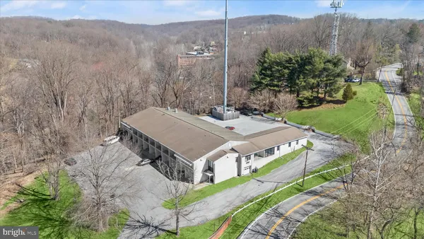 an aerial view of a house with a yard