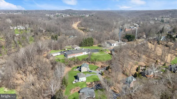 a view of an house with backyard and a tree