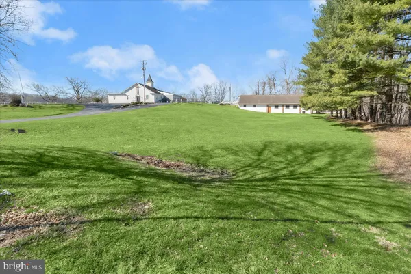 a view of yard with patio