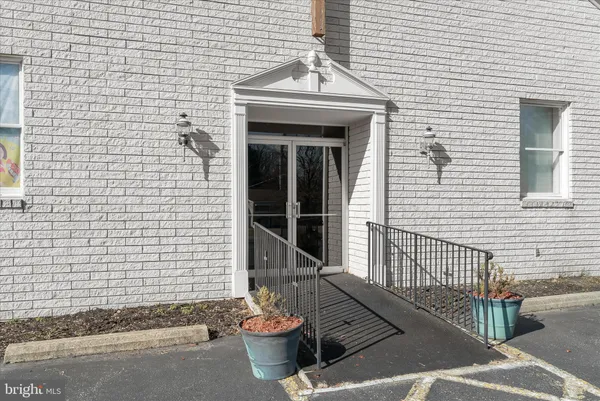 a front view of a building with parking space