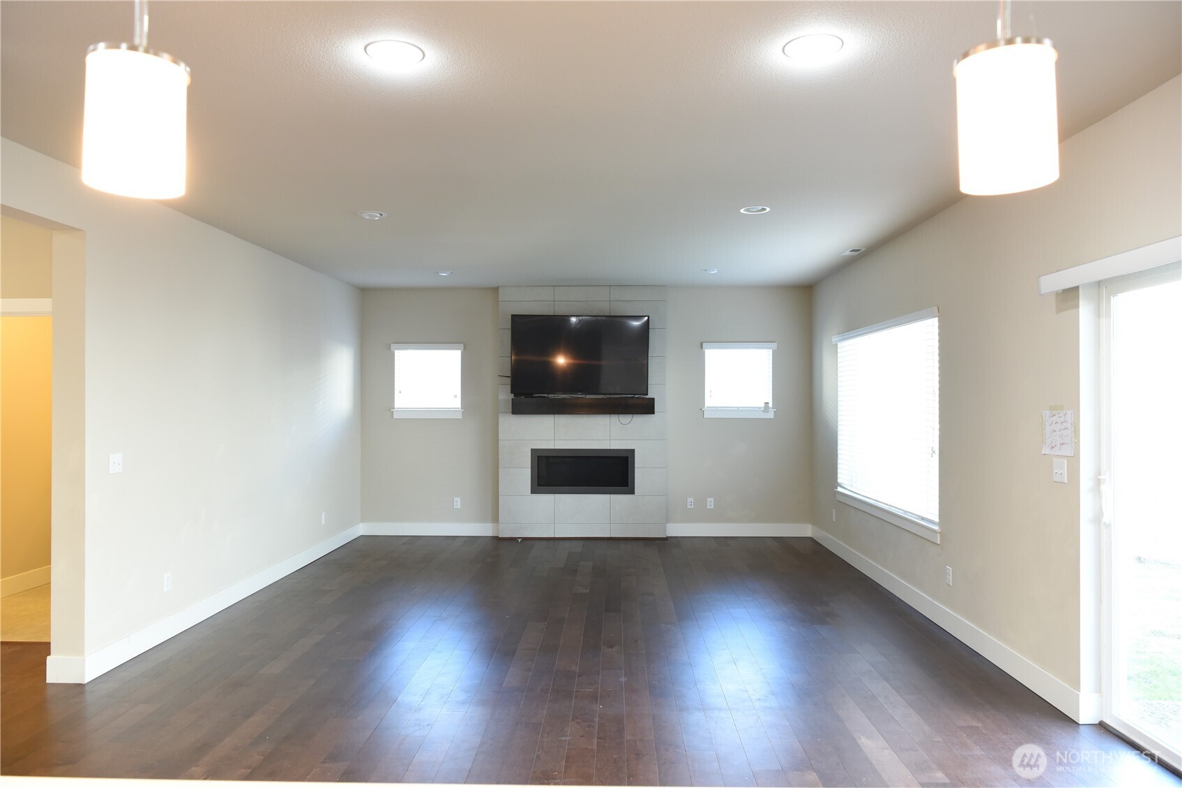 21417 43rd Drive Southeast, Unit 19 Bothell, WA 98021 - Photo 2 of 30 an empty room with wooden floor and windows